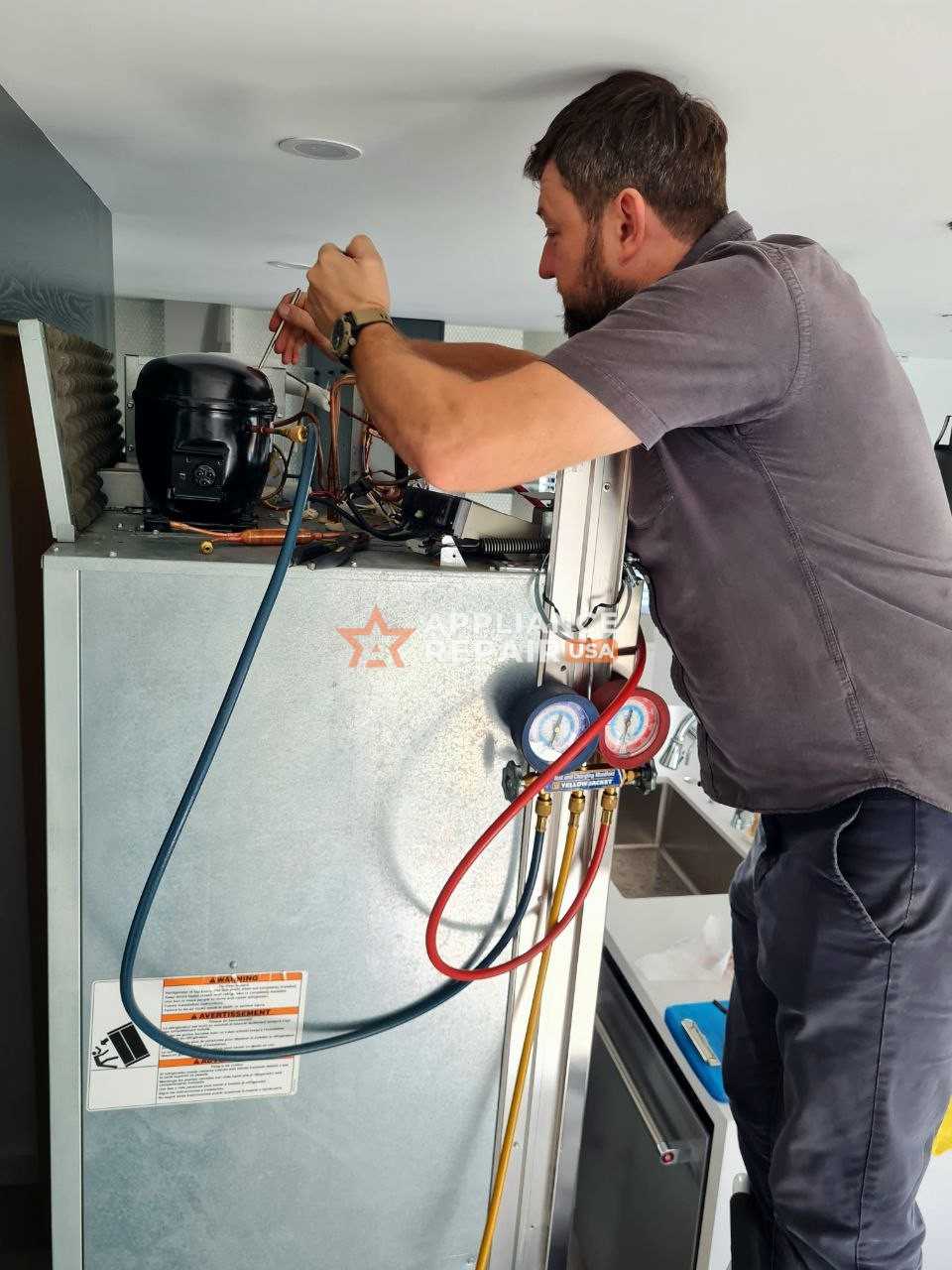 A man conducts maintenance on a refrigerator